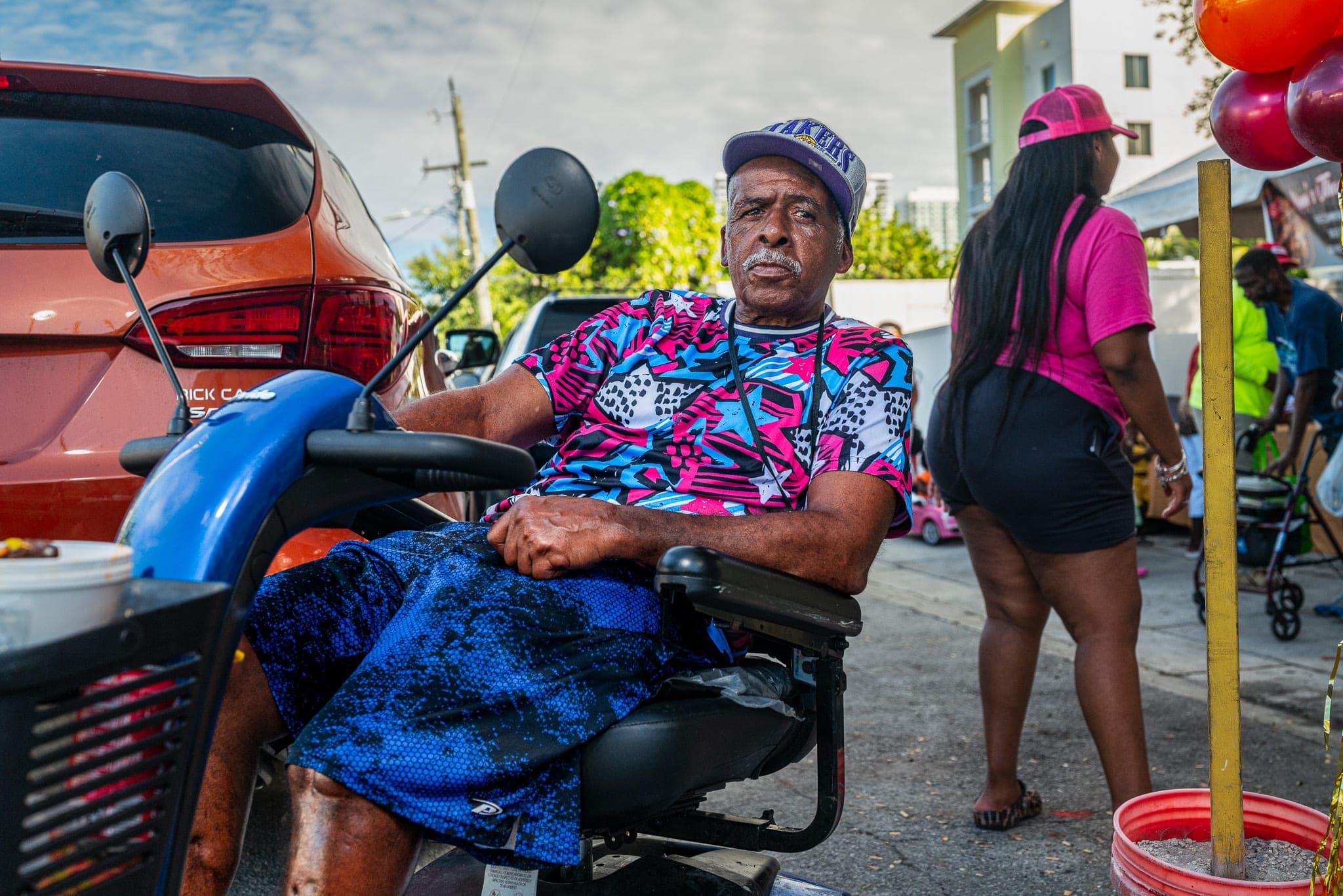 People on a lively community street — the kind of public-space moment that public infrastructure teams document