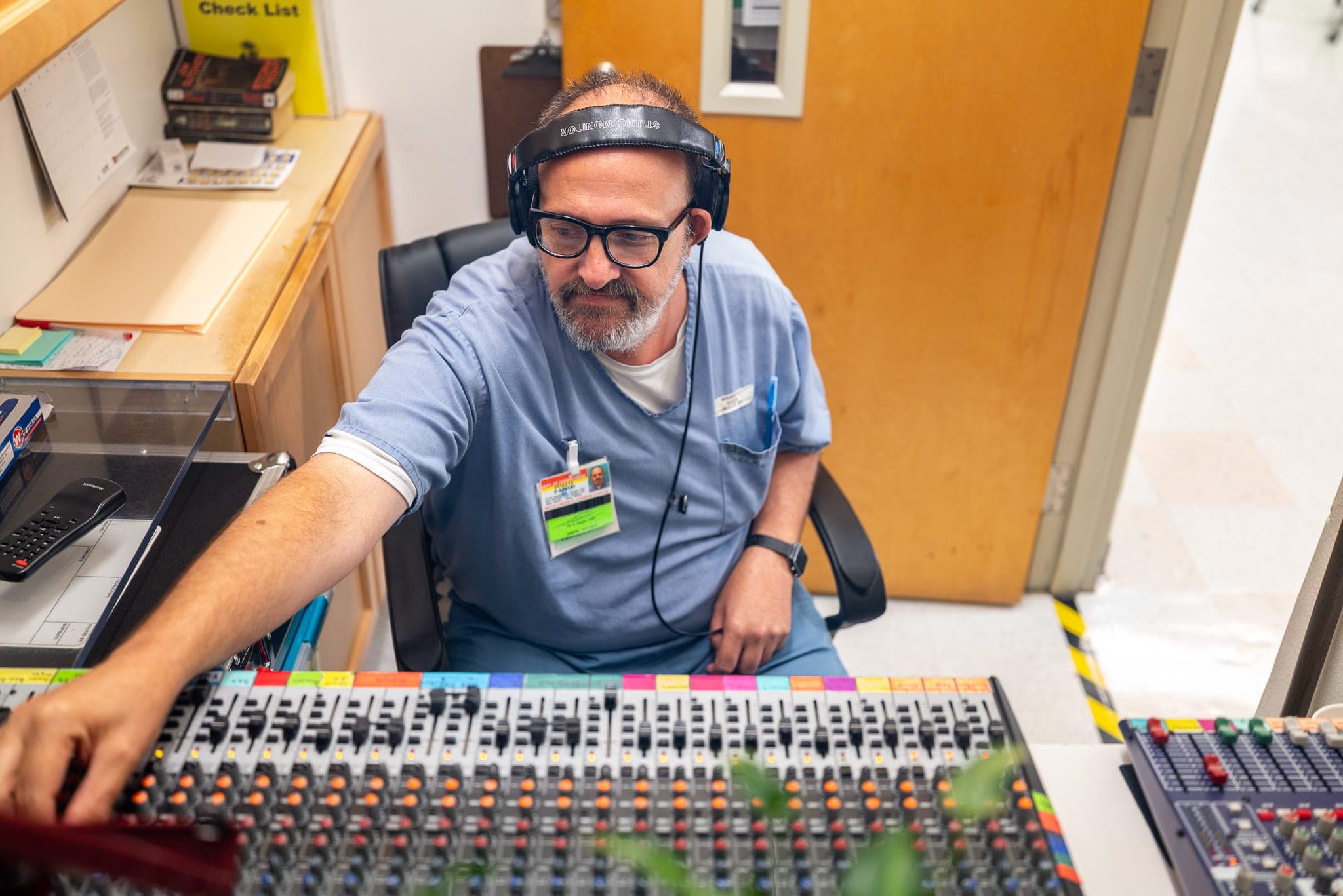 An operator at an audio console mixes a session — every stage of production running through one system