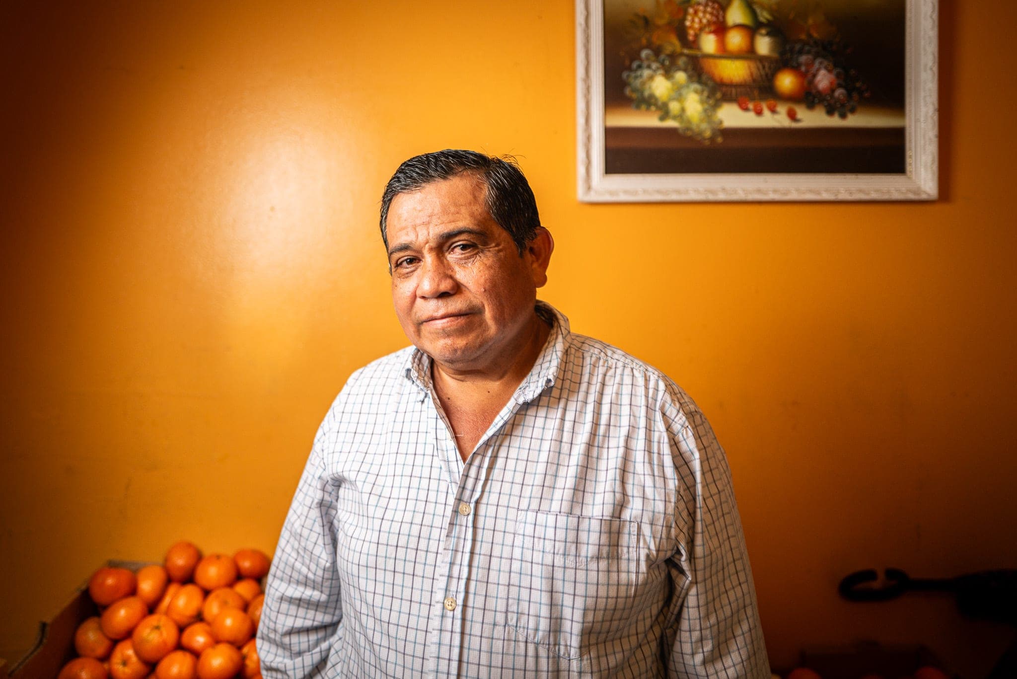 A subject photographed against a warm orange wall — real footage anchoring a production-house archive